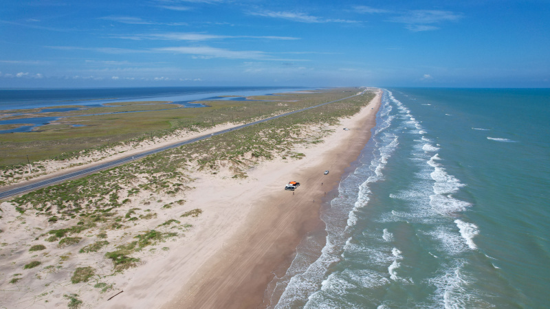 Scene looking down length of undeveloped beach at South Padre Island, Texas; Source: cropped from AdobeStock_533044190